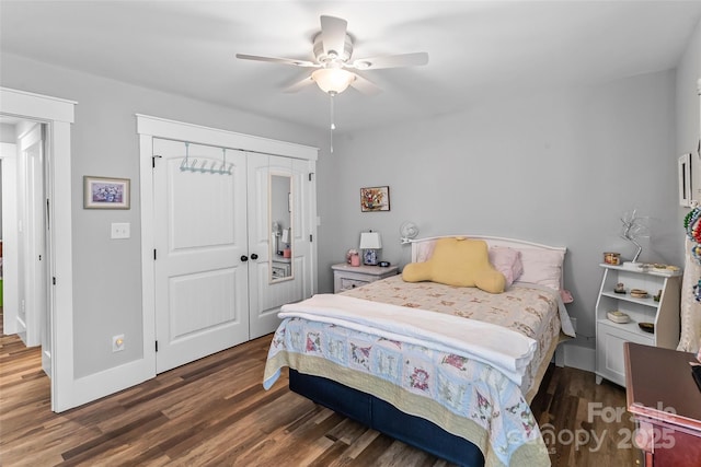 bedroom with ceiling fan, a closet, wood finished floors, and baseboards