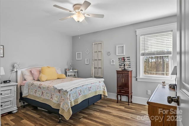 bedroom with ceiling fan, wood finished floors, and baseboards