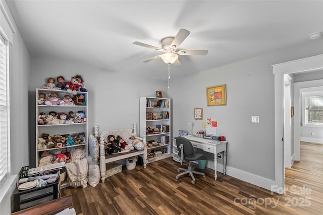 office area with a ceiling fan, baseboards, and wood finished floors