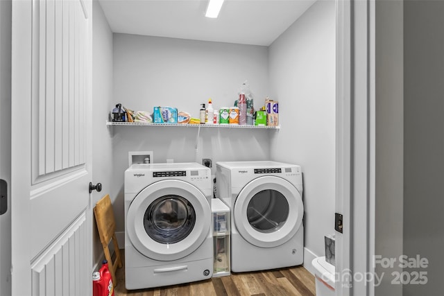 laundry room with laundry area, wood finished floors, and washer and dryer