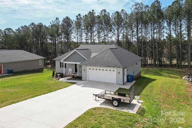 view of front facade featuring a garage, driveway, roof with shingles, board and batten siding, and a front yard