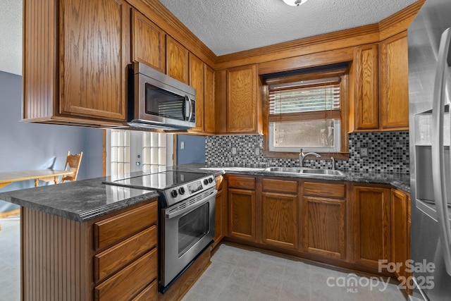 kitchen with brown cabinets, stainless steel appliances, and a sink