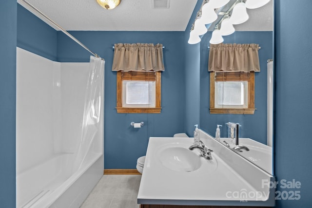 bathroom featuring toilet, a wealth of natural light, a textured ceiling, and visible vents