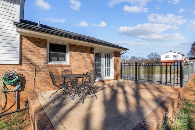 deck with a patio area, fence, outdoor dining area, and french doors