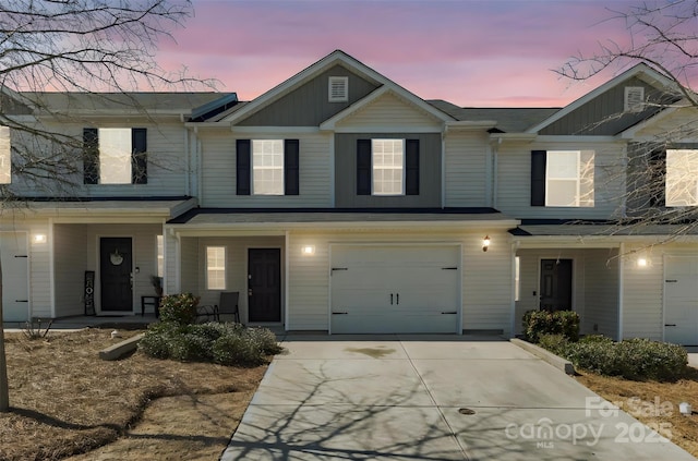 view of front of house featuring covered porch, driveway, and an attached garage