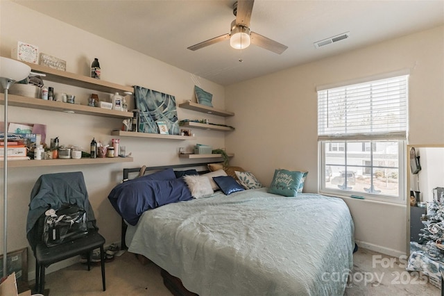 carpeted bedroom with baseboards, visible vents, and a ceiling fan