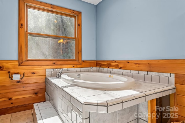 bathroom with tile patterned flooring and a bath