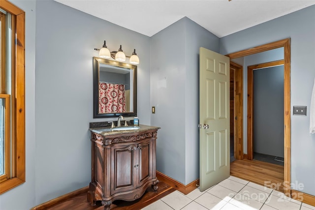 full bathroom featuring vanity, tile patterned floors, and baseboards