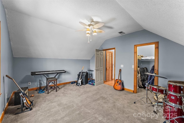 game room featuring visible vents, a textured ceiling, ceiling fan, and carpet floors