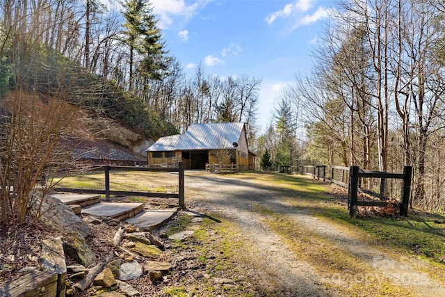 view of road featuring a barn and driveway