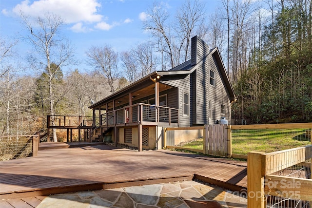 view of home's exterior featuring a deck and a chimney