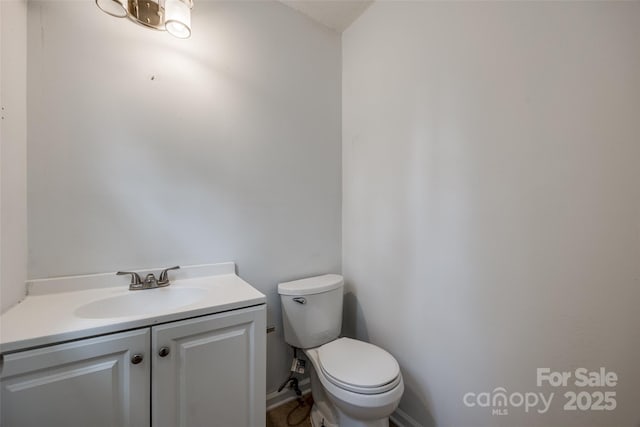 bathroom featuring toilet and vanity