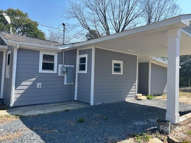 view of side of home featuring an attached carport