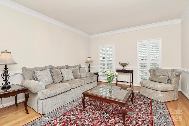 living room with baseboards, crown molding, and light wood-style floors