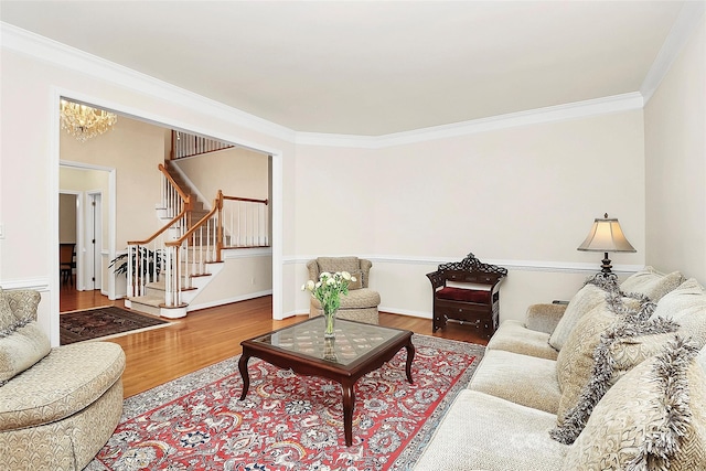 living room with baseboards, wood finished floors, stairs, and crown molding