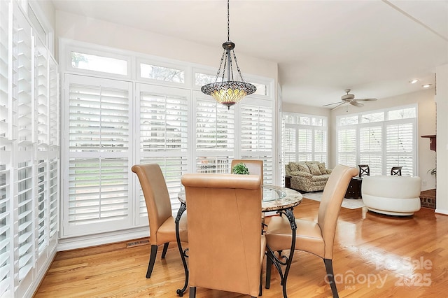 sunroom with a ceiling fan and visible vents