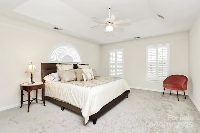 carpeted bedroom featuring visible vents, a ceiling fan, and baseboards