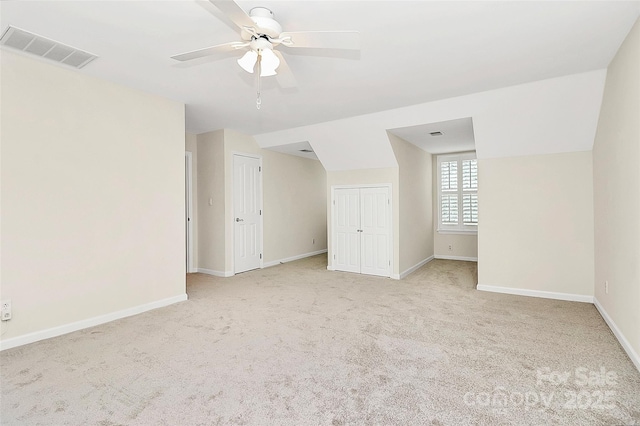 bonus room featuring baseboards, visible vents, and light carpet