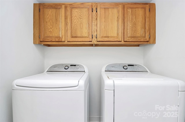 laundry room with cabinet space and separate washer and dryer