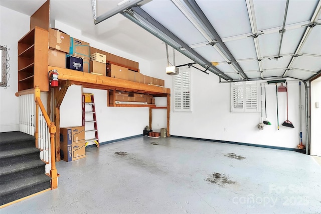 garage with a garage door opener and baseboards