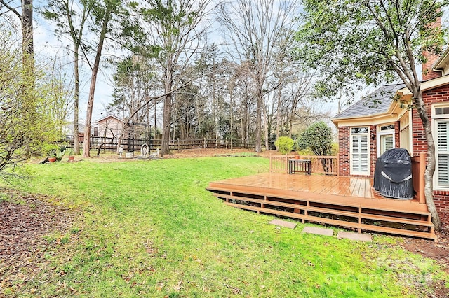 view of yard with a wooden deck and fence