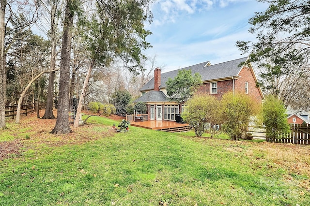 view of yard with a deck and fence