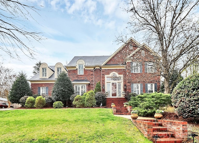 view of front facade featuring a front lawn and brick siding