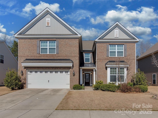 traditional-style home featuring a garage, concrete driveway, and brick siding