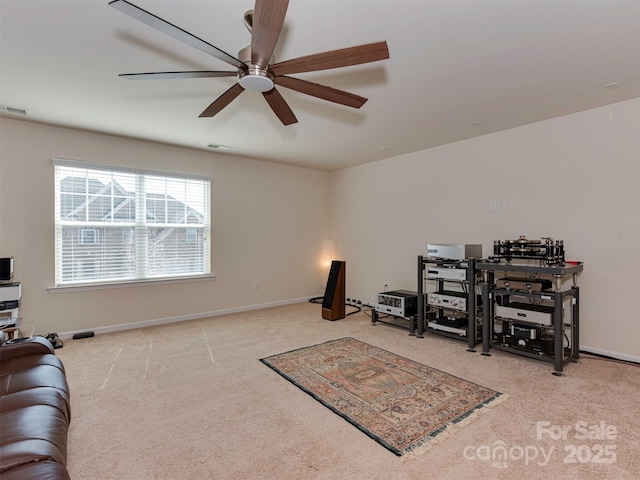 interior space with carpet flooring, ceiling fan, visible vents, and baseboards