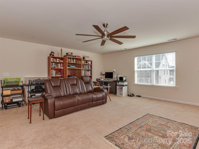 carpeted living area featuring ceiling fan, visible vents, and baseboards