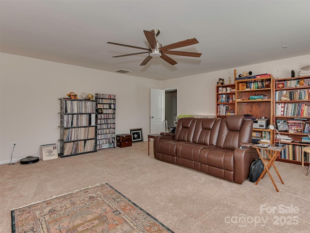 carpeted living room featuring visible vents and a ceiling fan