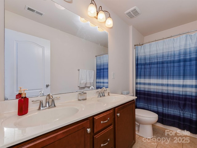 bathroom featuring tile patterned flooring, visible vents, and a sink