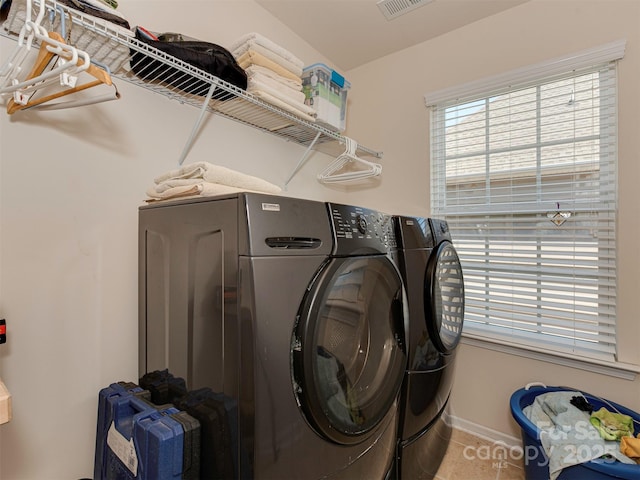 clothes washing area with laundry area, tile patterned flooring, baseboards, and independent washer and dryer