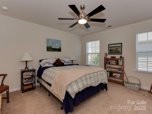 bedroom featuring visible vents, baseboards, and light colored carpet