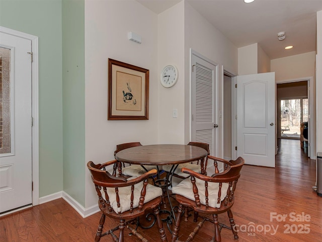 dining space featuring recessed lighting, baseboards, and wood finished floors