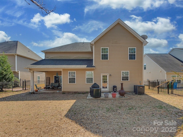 rear view of house with central AC, a patio, and a fenced backyard