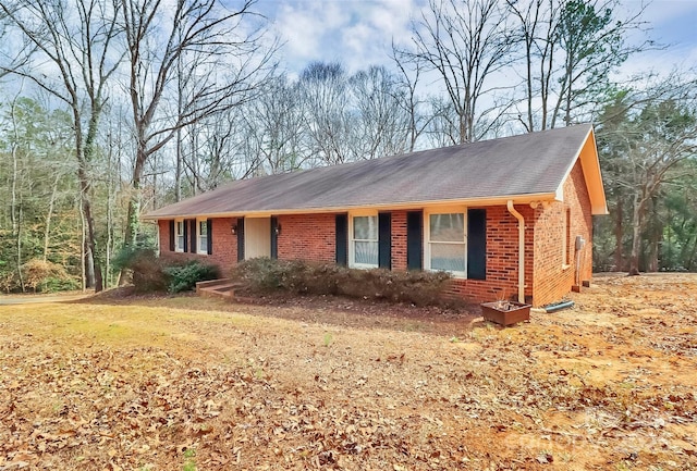 ranch-style house featuring brick siding