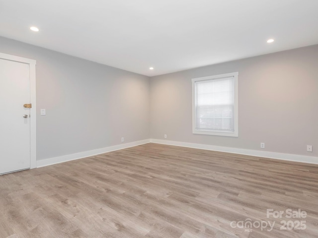 unfurnished room with light wood-type flooring, baseboards, and recessed lighting