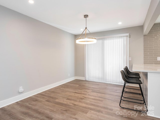 interior space featuring recessed lighting, light wood-style flooring, and baseboards