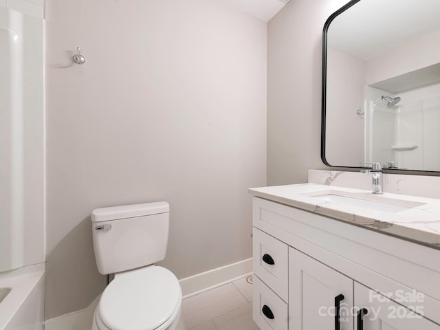 full bathroom with baseboards, toilet, tile patterned floors, walk in shower, and vanity