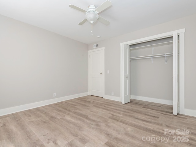 unfurnished bedroom featuring a closet, visible vents, ceiling fan, light wood-type flooring, and baseboards