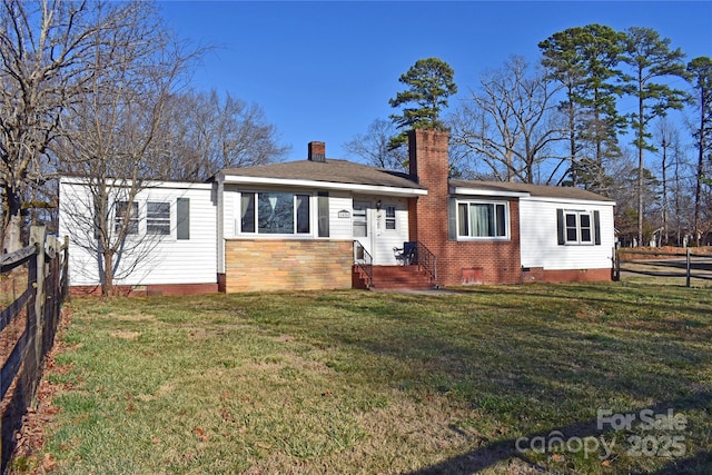 back of property featuring a yard, crawl space, a chimney, and fence