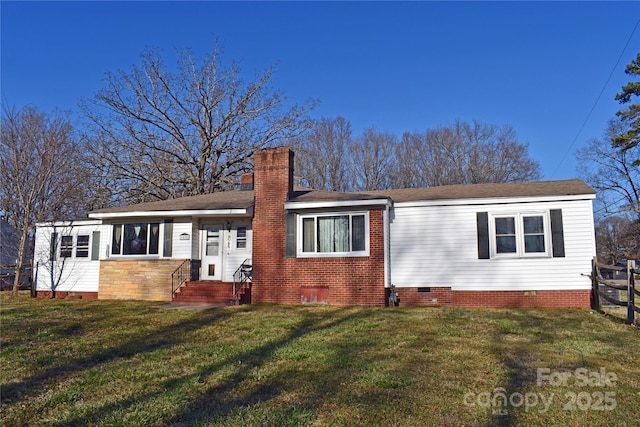 back of property with crawl space, a yard, a chimney, and fence