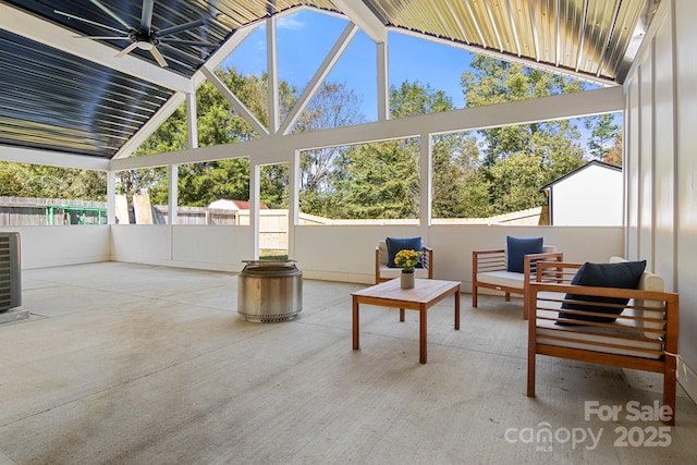 sunroom / solarium with ceiling fan and vaulted ceiling