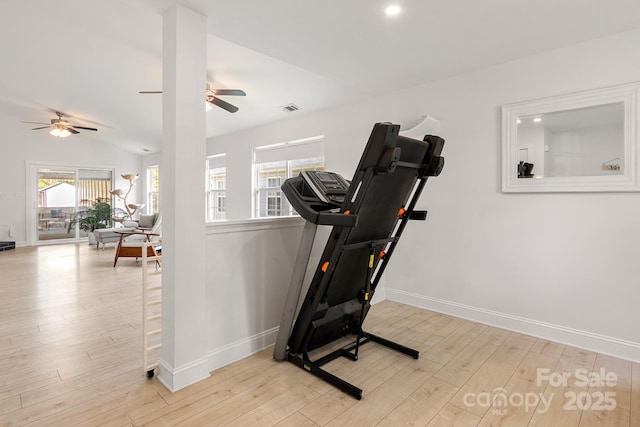 workout room featuring lofted ceiling, baseboards, visible vents, and wood finished floors