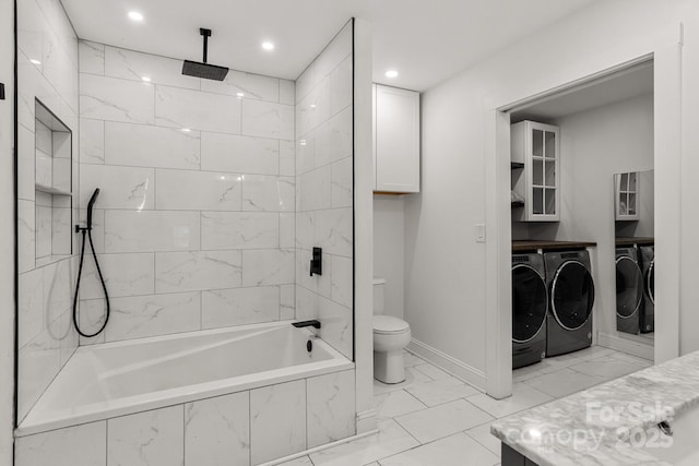 bathroom featuring toilet, a combined bath / shower with rainfall shower, vanity, marble finish floor, and independent washer and dryer