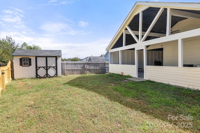 view of yard featuring an outbuilding, a storage shed, and a fenced backyard