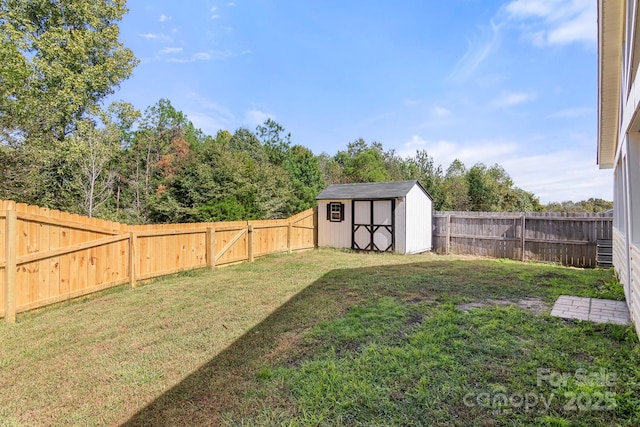 view of yard featuring an outbuilding, a fenced backyard, and a shed