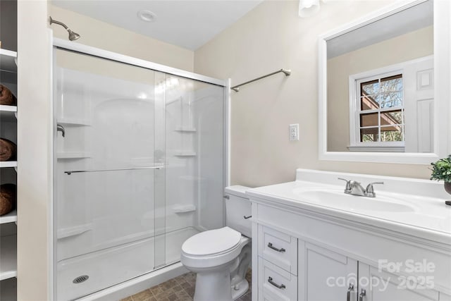 full bath with toilet, a shower stall, and vanity