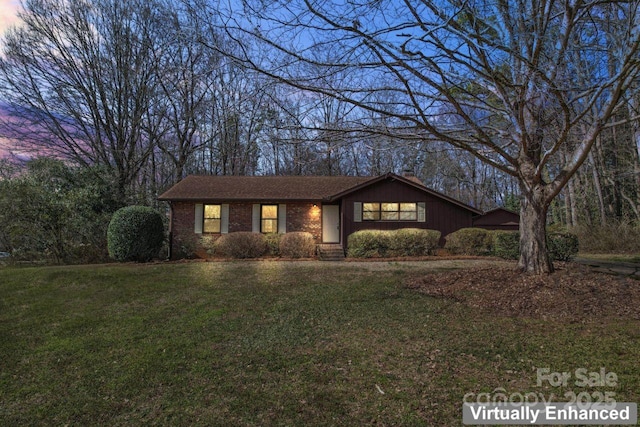 view of front of house featuring a front yard and brick siding